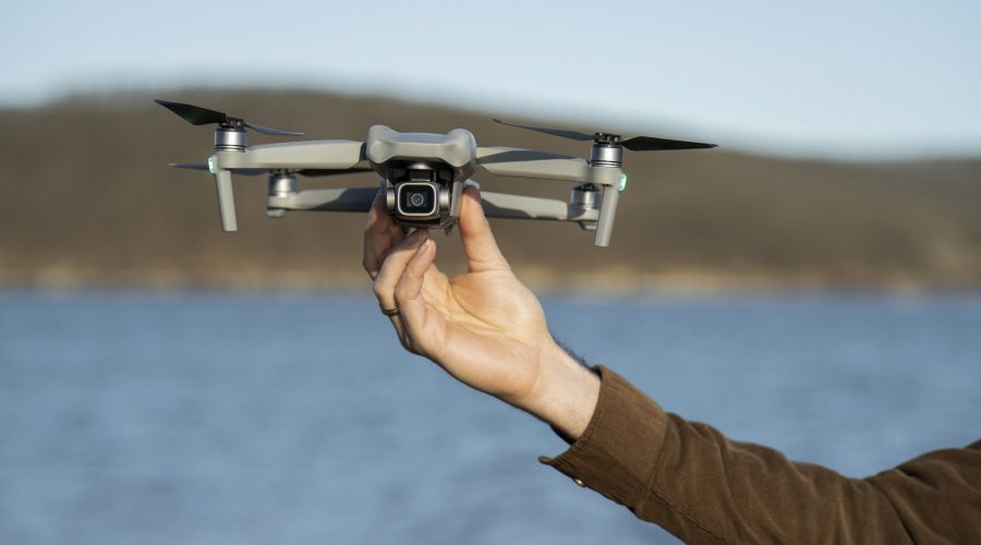 man-s-hand-holding-drone-outdoors